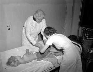 Polio, Sr. Kenney examining child,7%20Examining%20%20a%20Child