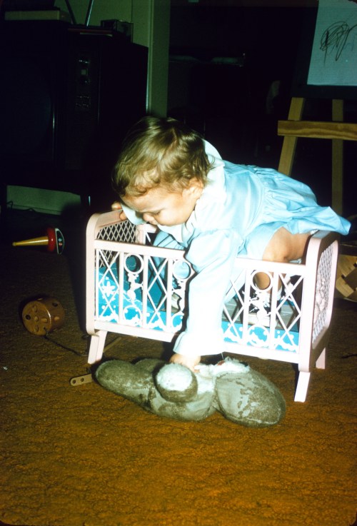 1972 Mar Sherry with Foofoo trying out a bed too small 2