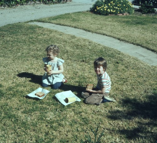 1974 Feb Scott and Sherry eating on the front lawn Altadena house